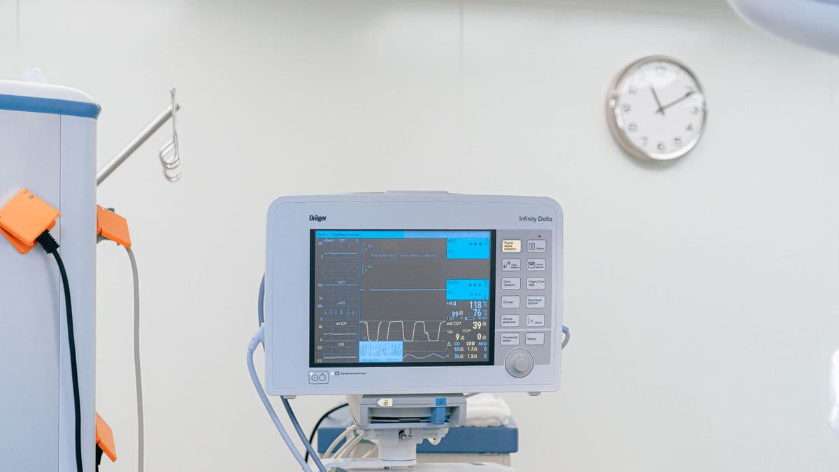 A patient monitor displaying vital signs in a clinical room