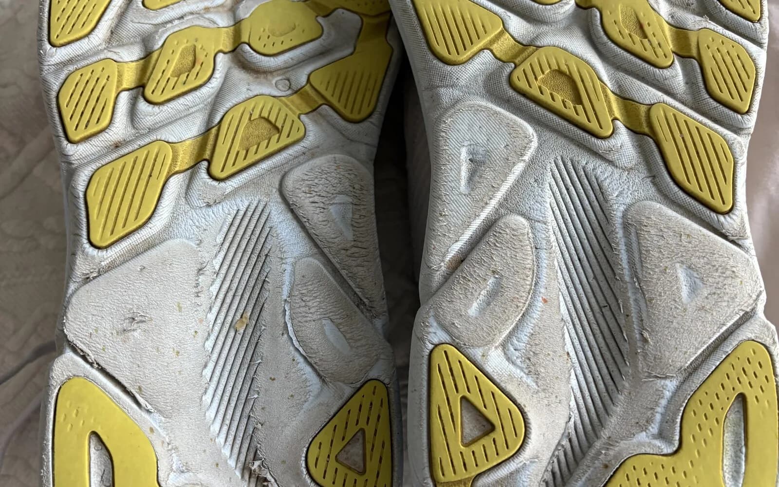 Worn Hoka Clifton 9 running shoes showing outsole wear